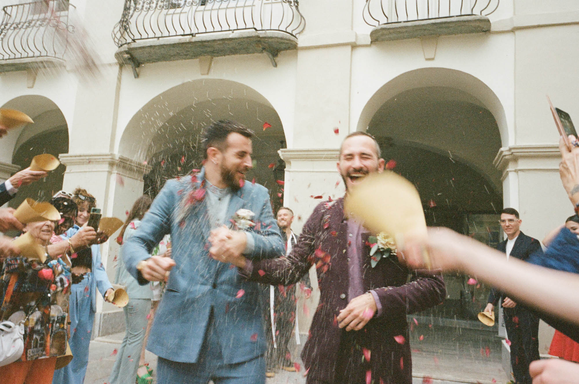 Wedding guests toss confetti as queer couple leaves their ceremony in Torino Italy