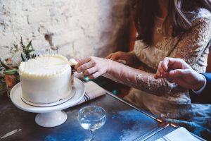 bride cutting wedding cake