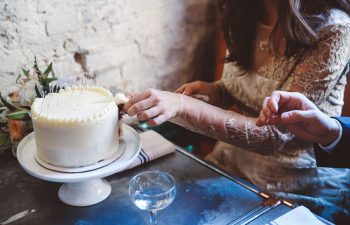bride cutting wedding cake