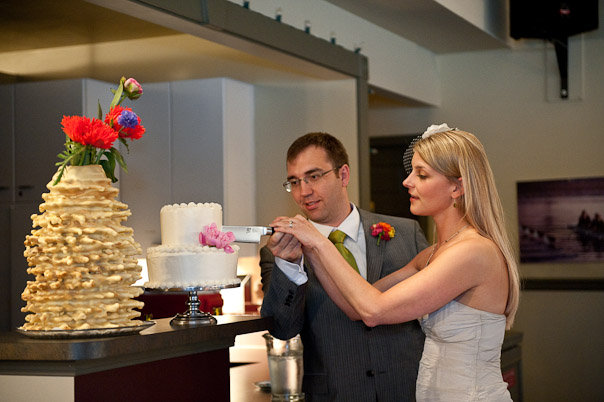 The bride and groom cutting the DIY wedding cake.