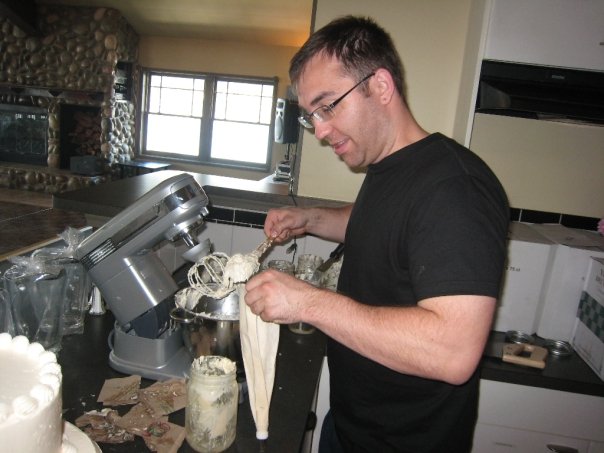 Man practicing making buttercream icing for a DIY wedding cake
