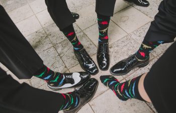 groom and groomsmen wearing dinosaur socks