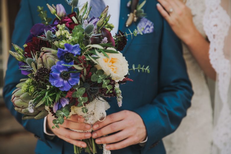 man holding bride's bouquet