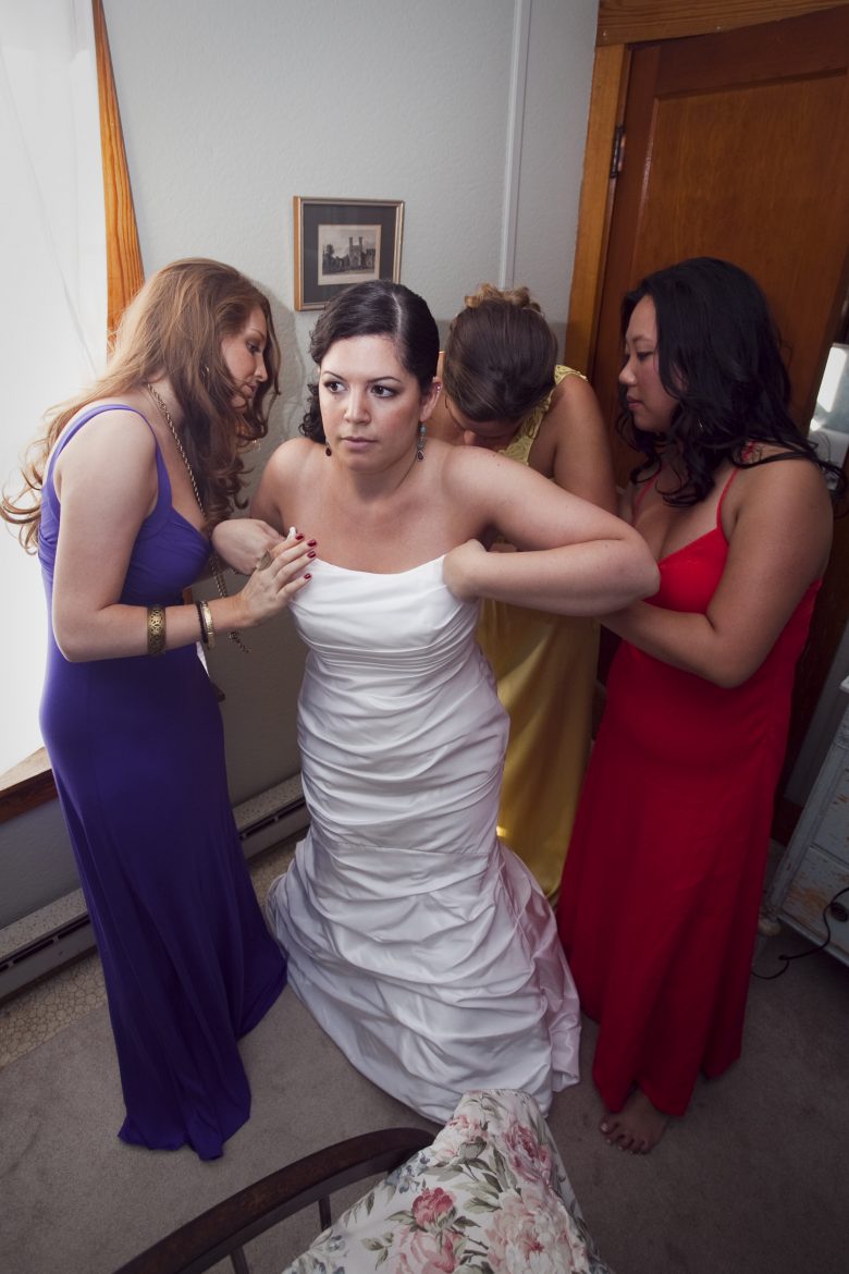 bride getting dressed on her wedding day