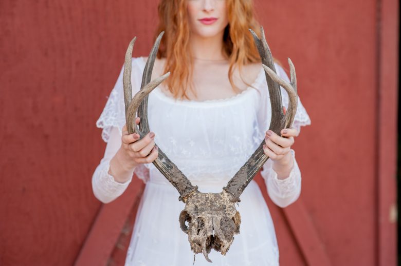 woman holding cow skull