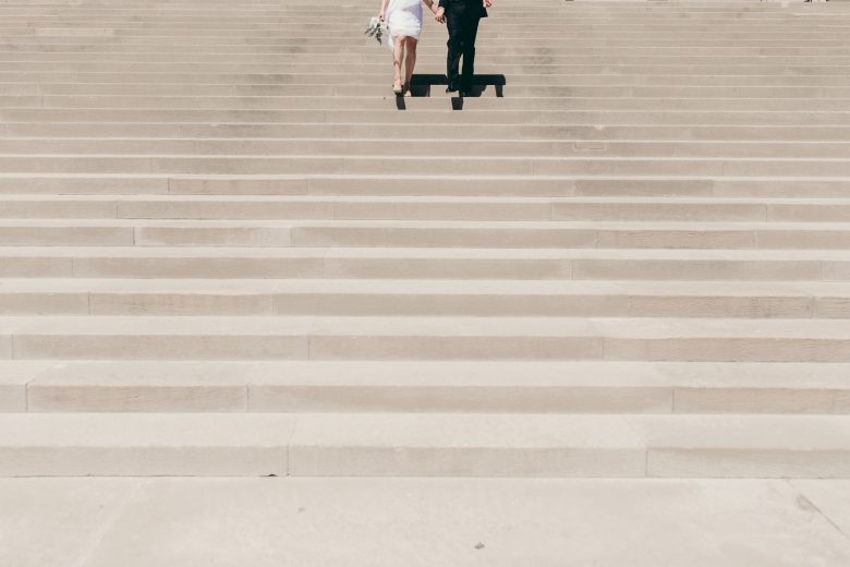 bride and groom walking up stairs