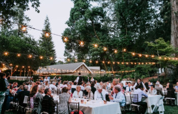 wedding guests at tables under cafe lights