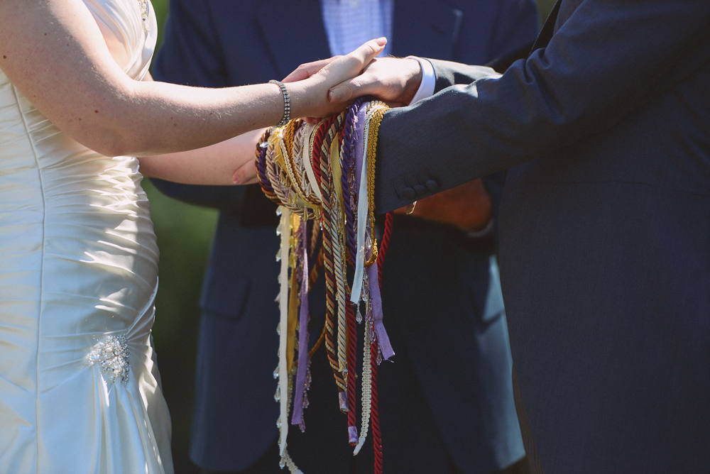 bride and groom during handfasting ceremony.