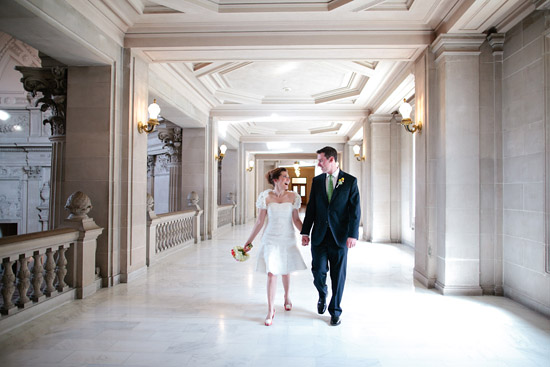 couple holding hands and walking down hallway at San Francisco City Hall