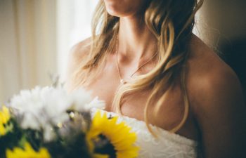 bride holding sunflower bouquet