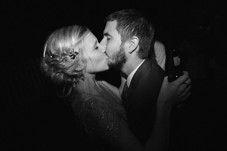 black and white photo of couple kissing at wedding