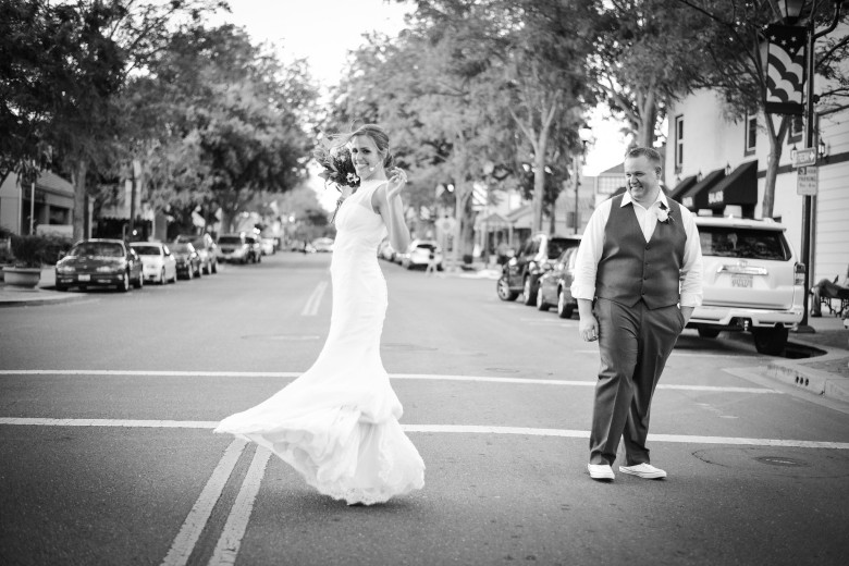 black and white photo of bride and groom in street