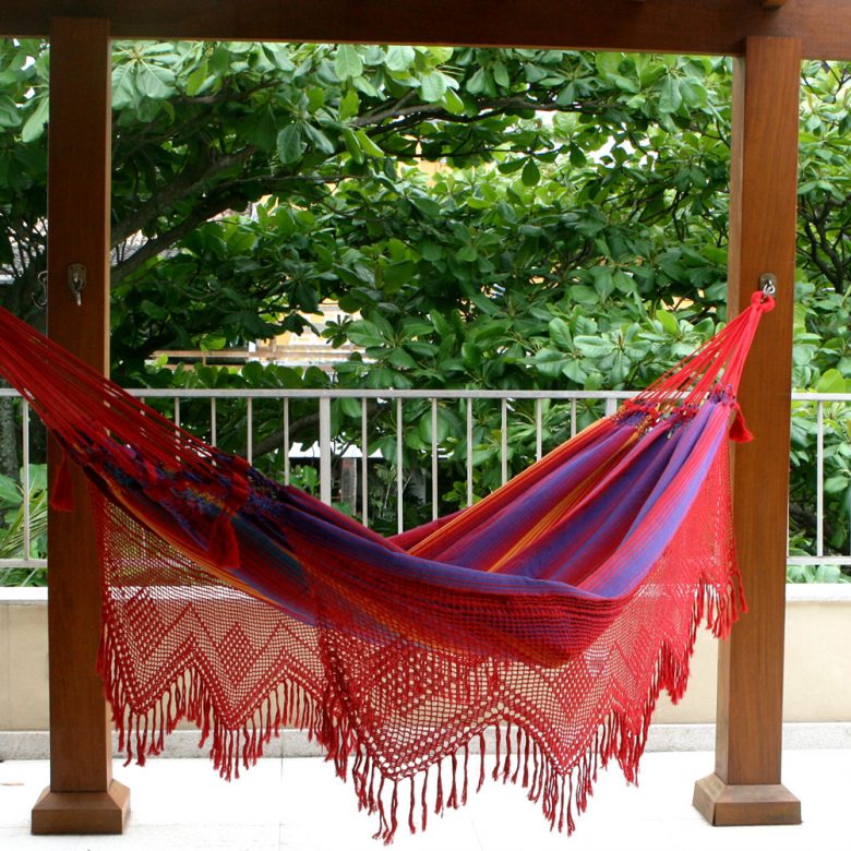colorful hammock hanging on a porch