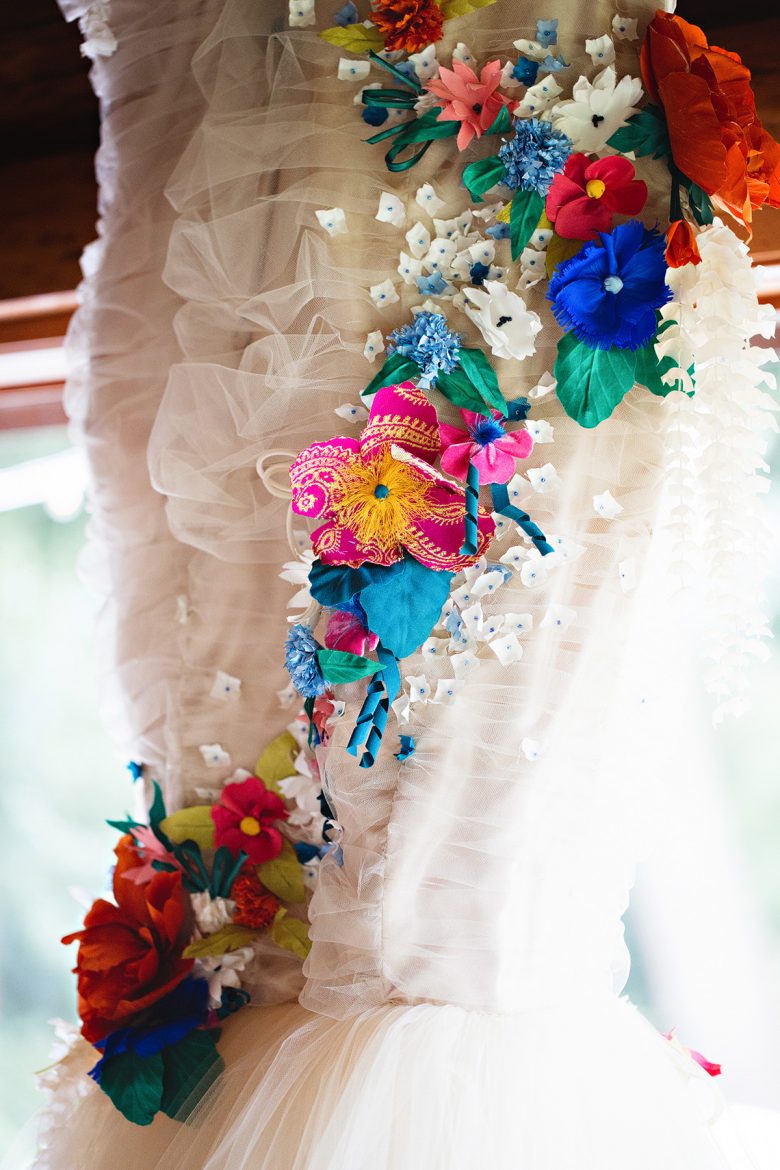 Closeup of handmade textile flower details on a cream tulle dress | A Practical Wedding