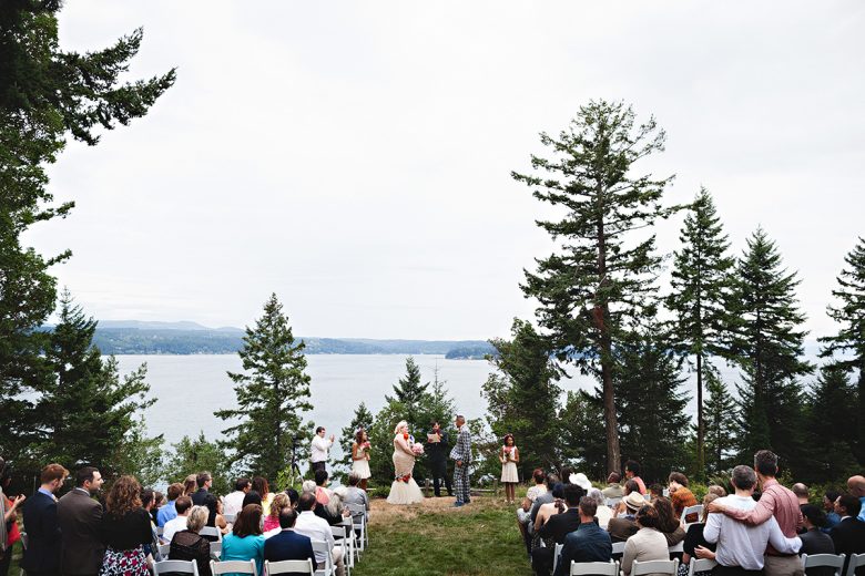 Lakeside wedding scene with many tall evergreens | A Practical Wedding