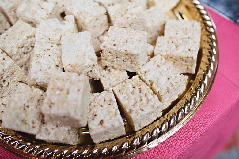 Close up of rice krispy treats on a gold platter | A Practical Wedding