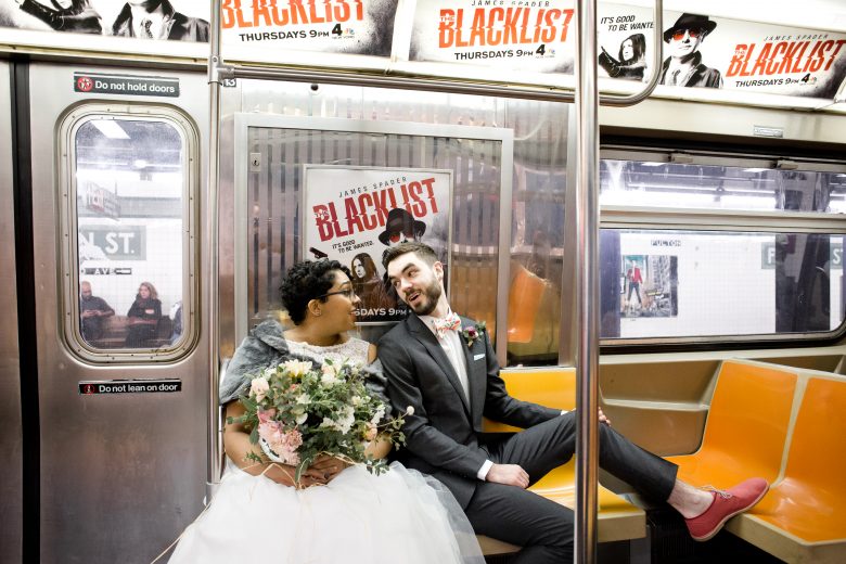 bride and groom taking the subway to their wedding