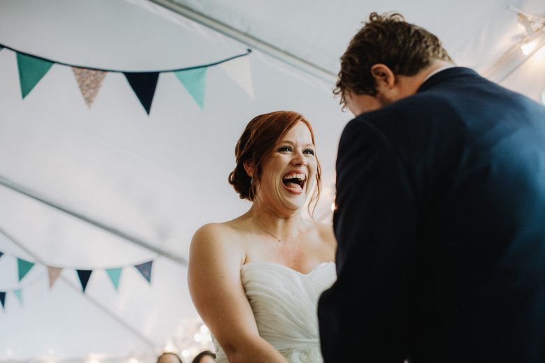 bride laughing while getting married