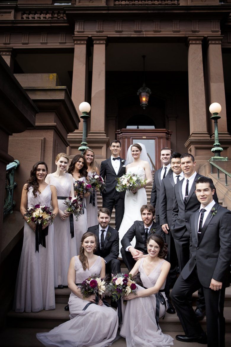 Bridal party standing in front of wedding site