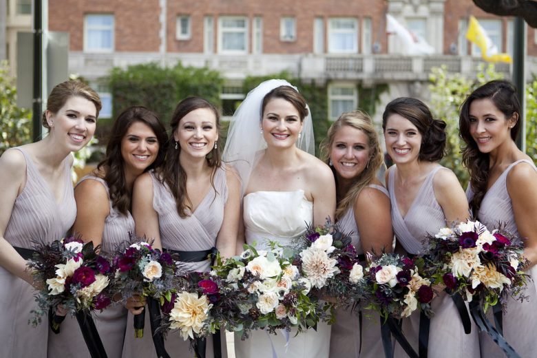 Bridesmaids in lavender dresses with bride