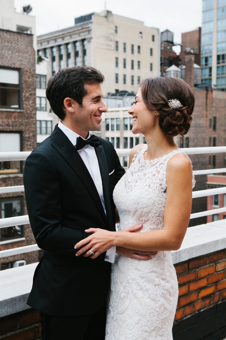 smiling bride and groom on rooftop
