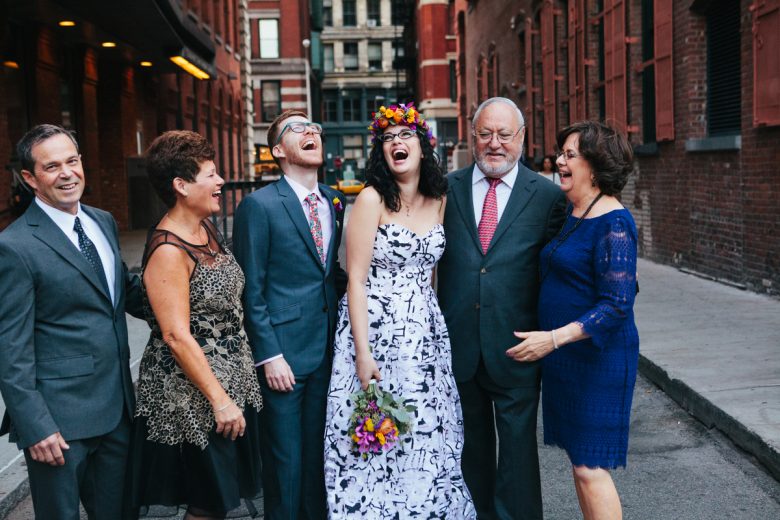 portrait of family laughing on wedding day