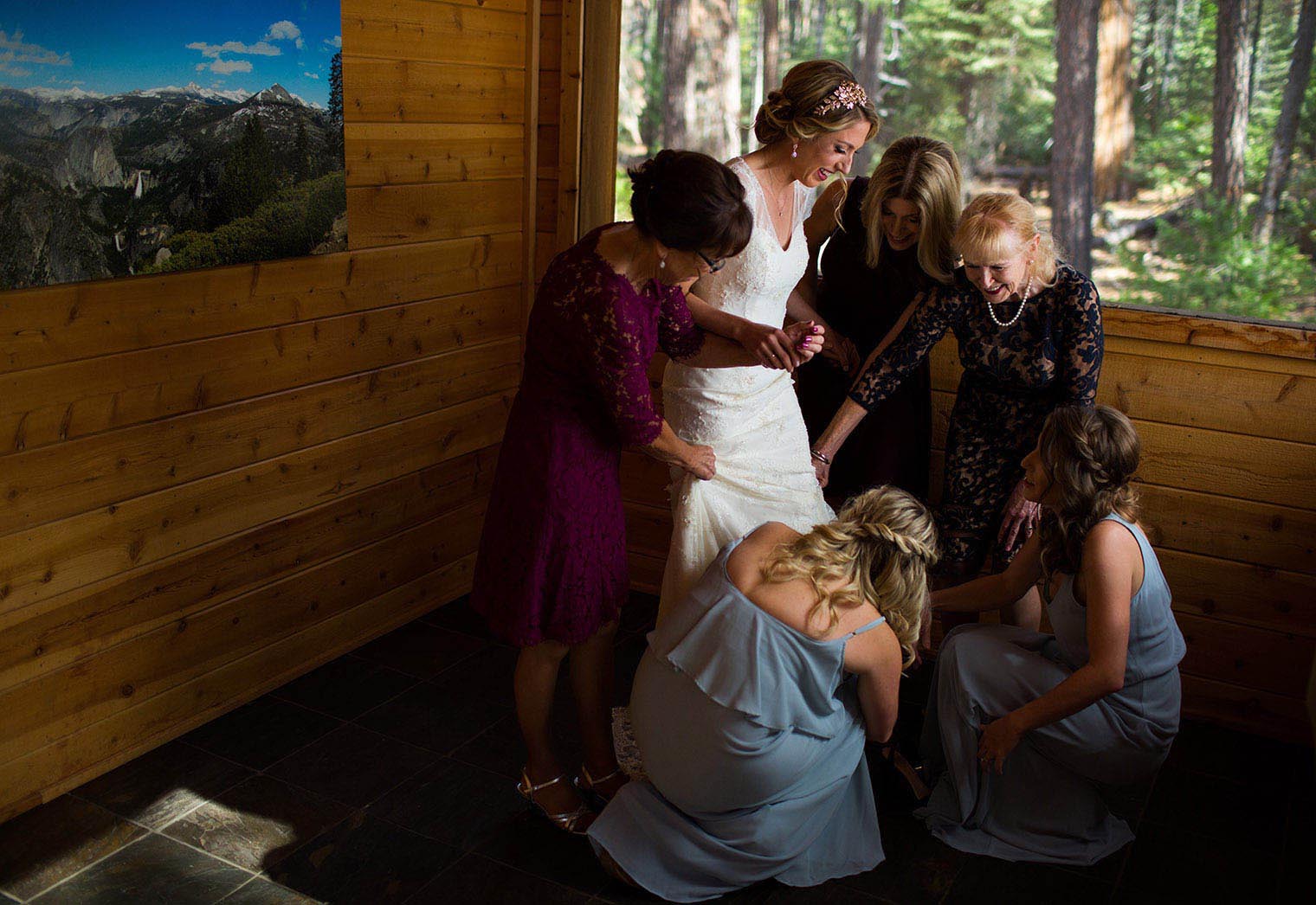women help a bride put her dress on