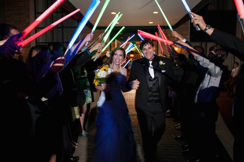 bride and groom wedding exit with lightsabers