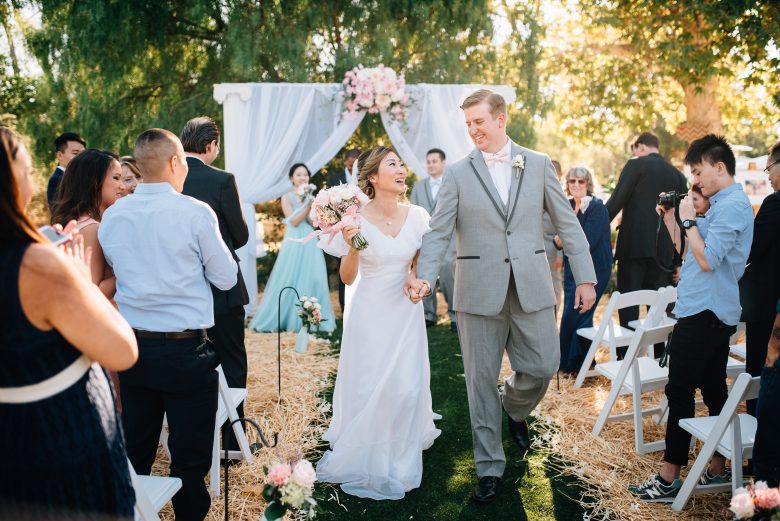 couple recessing down the aisle at outdoor wedding