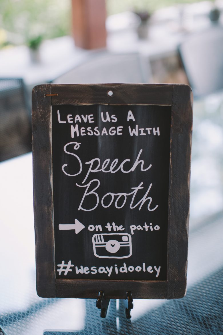 wooden sign that says "leave us a message with speechbooth"