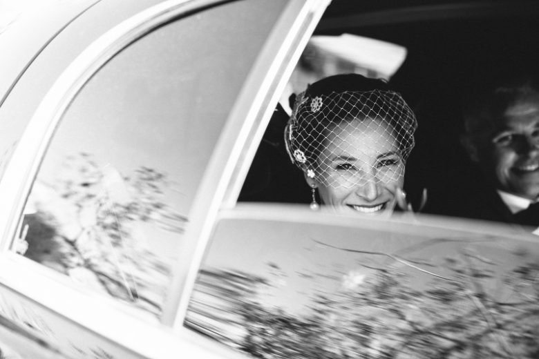black and white photo of bride and groom in the car