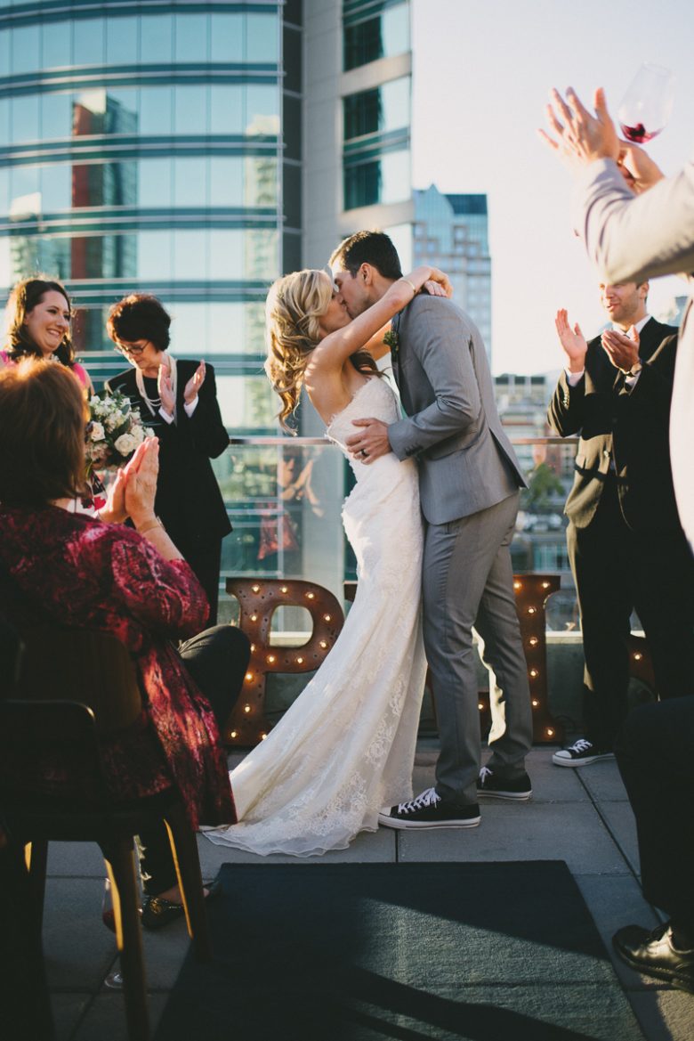 bride and groom kissing after wedding ceremony