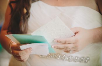 bride looking at card from groom