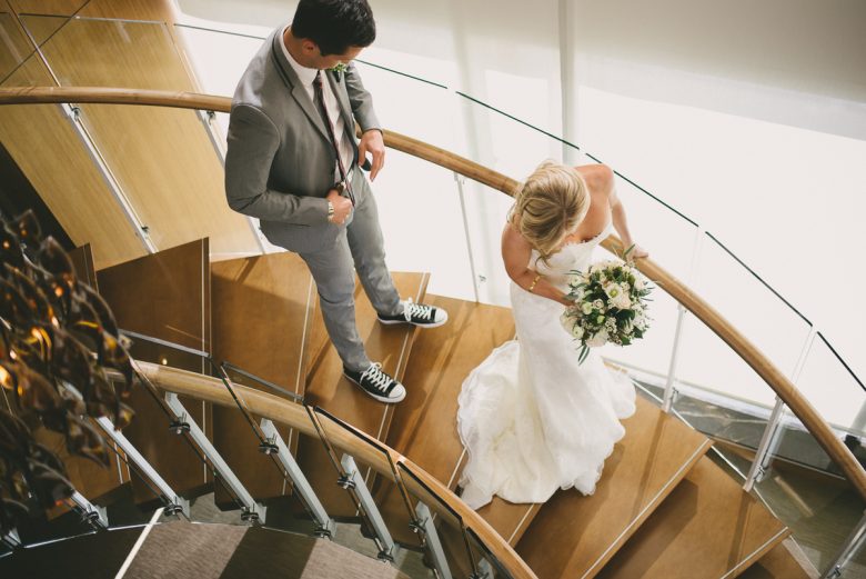 Bride and groom coming down circular staircase