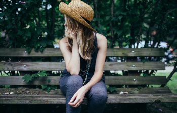 Blond woman in a hat looking away