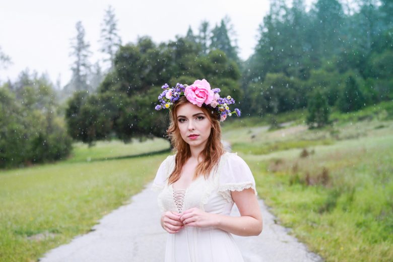 bride standing in the rain