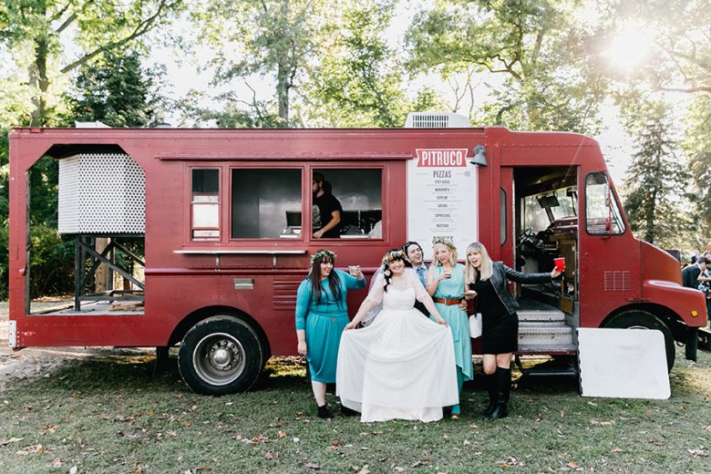 bride and bridesmaids in front of food truck