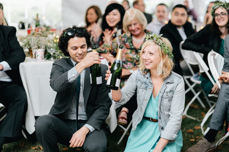 wedding guests holding champagne bottles