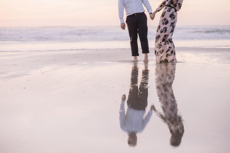 couple's reflection on the beach