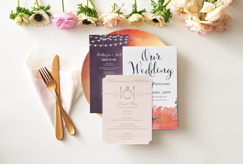 Wedding table settings with invitations on the plate