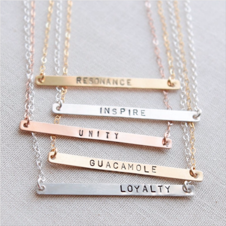 text stamped metallic necklaces of different words and hues