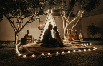 Two persons hanging out with a teepee indicating wedding appropriation