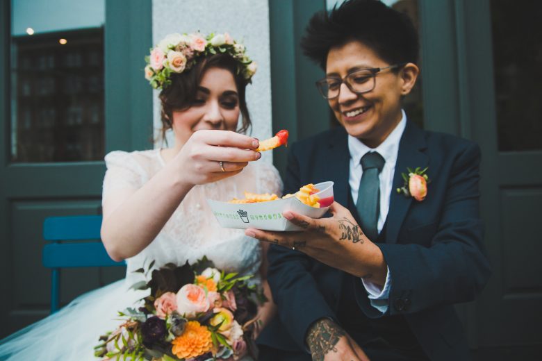 couples eating fries on wedding day
