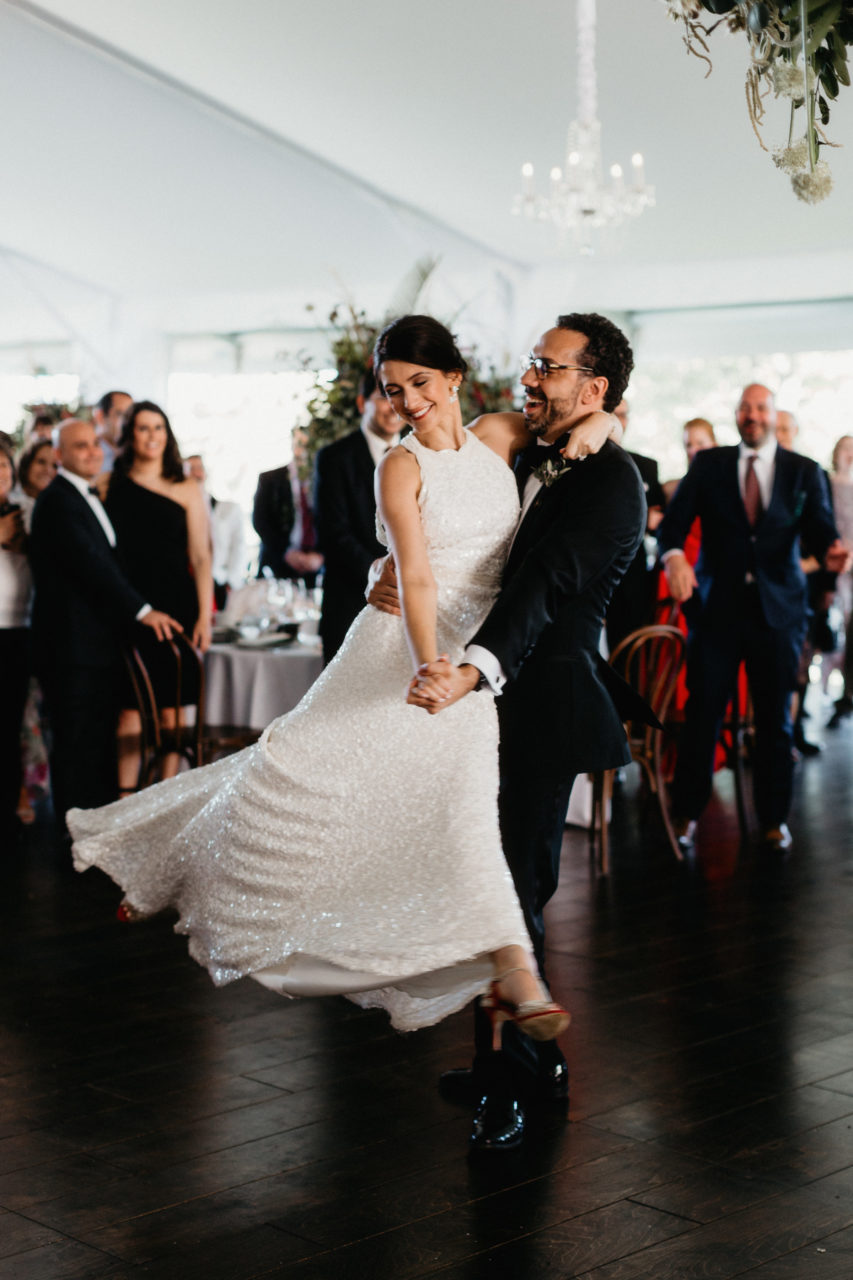 A wedding couple dance joyfully at a reception in a photo by Shaw Photography Co.