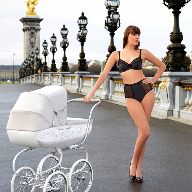 woman wearing black lingerie and pushing a stroller