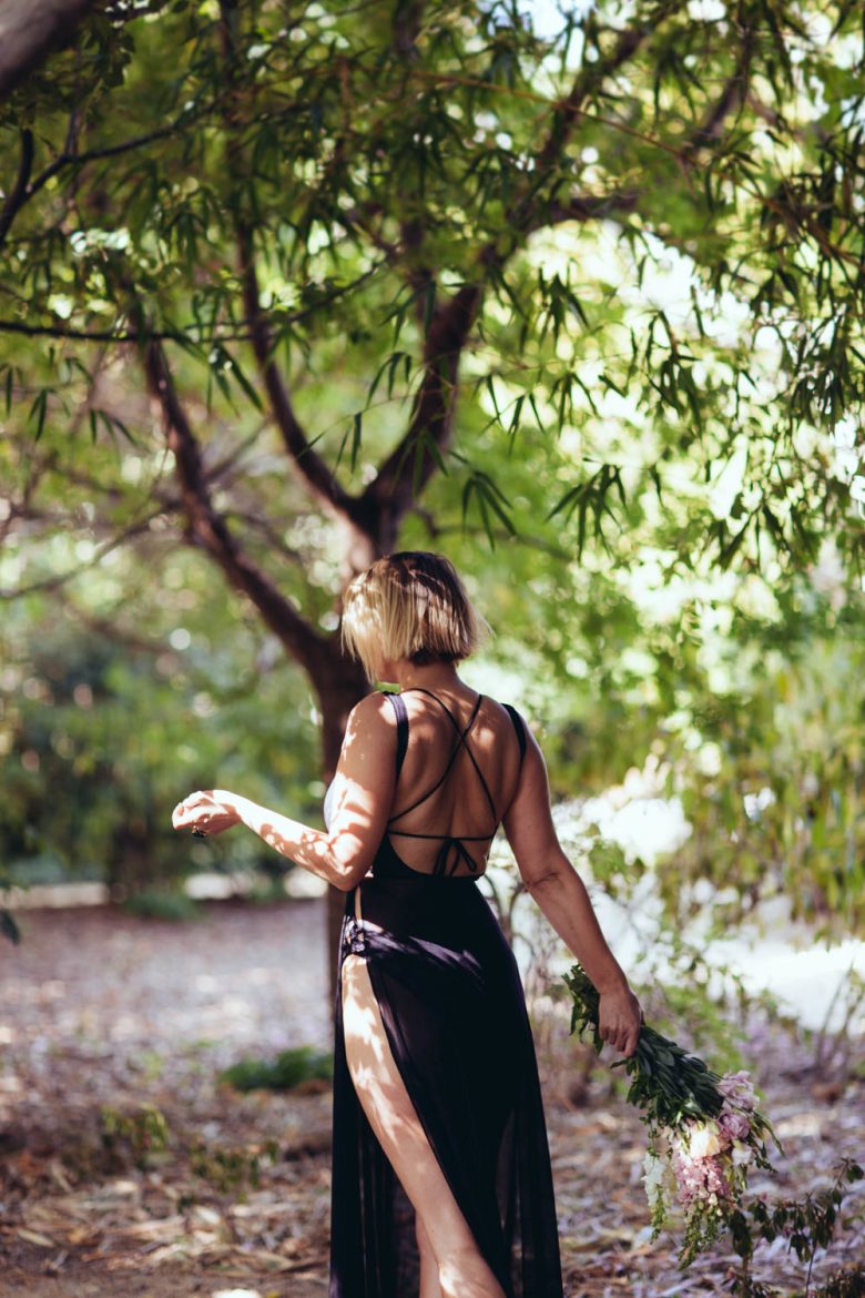 woman walking under a tree