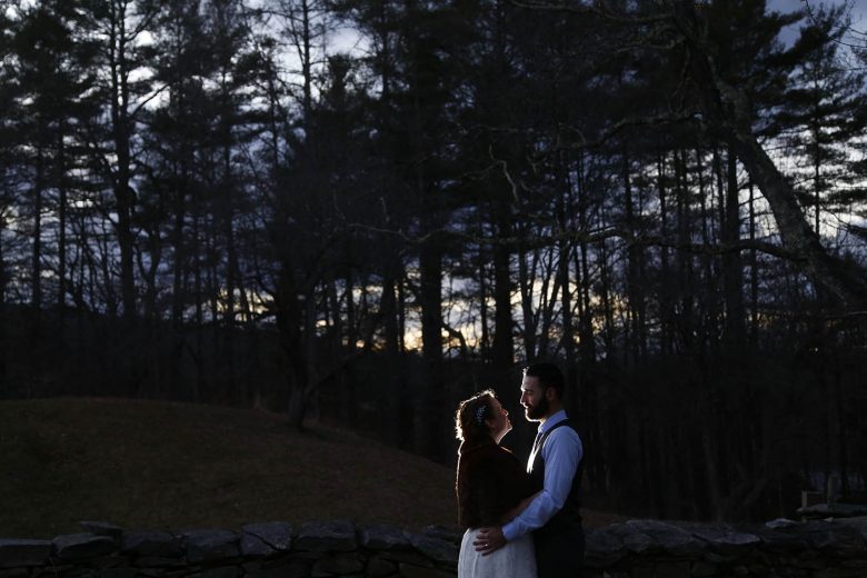 bride and groom in woods at dusk