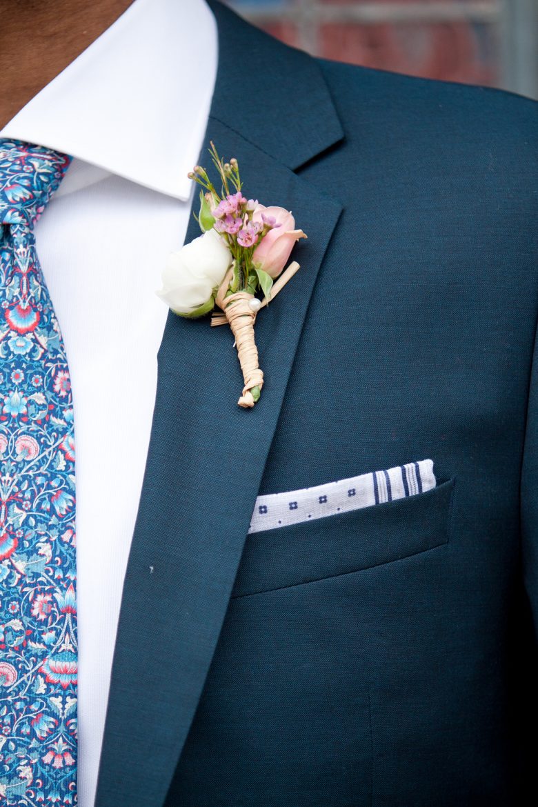 groom wearing flowers