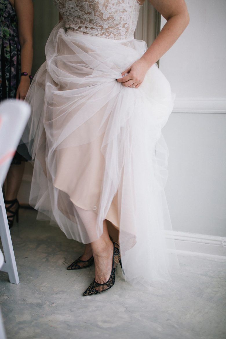 bride with tulle dress and black shoes
