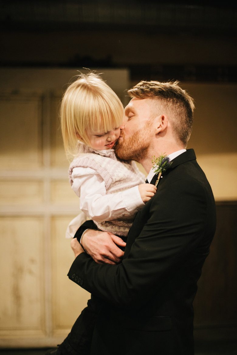 groom holding child